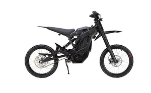 Side view of the eMOTO eRide Pro SS 2.0 electric dirt bike, featuring a rugged frame, 19x3 off-road tires, and a sleek black and red design.