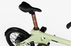 Lime green Urtopia Carbon Fold 1 eBike shown folded, highlighting its compact design and lightweight carbon frame.
