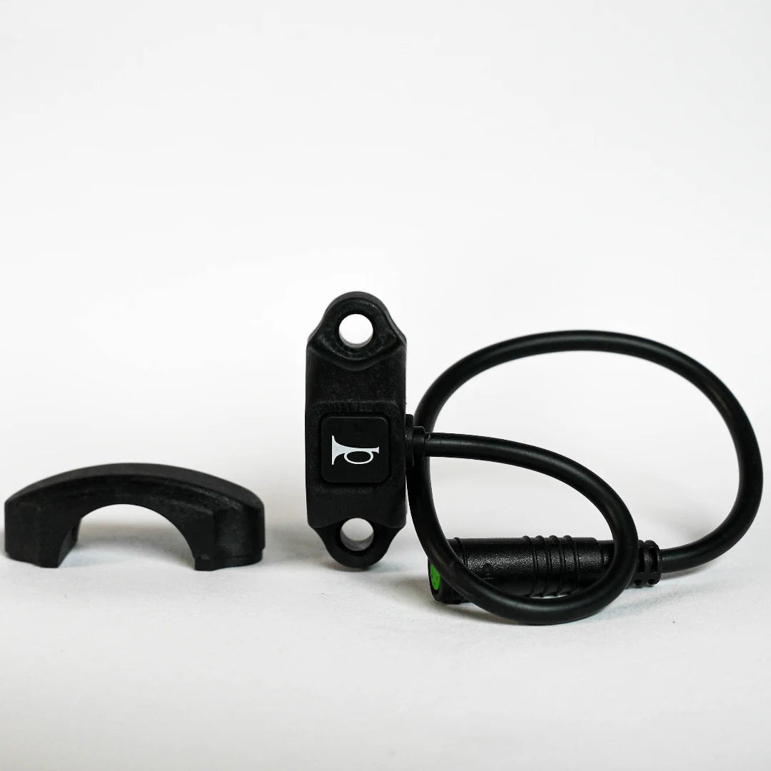 Close-up of a black eBike horn switch designed for Super73, featuring a compact rectangular button with wiring attached.