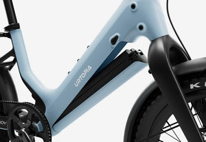 Side view of the Urtopia Carbon Joy Ultra eBike in Glacier Blue, showcasing its sleek carbon frame, integrated battery, and modern design against a white background.