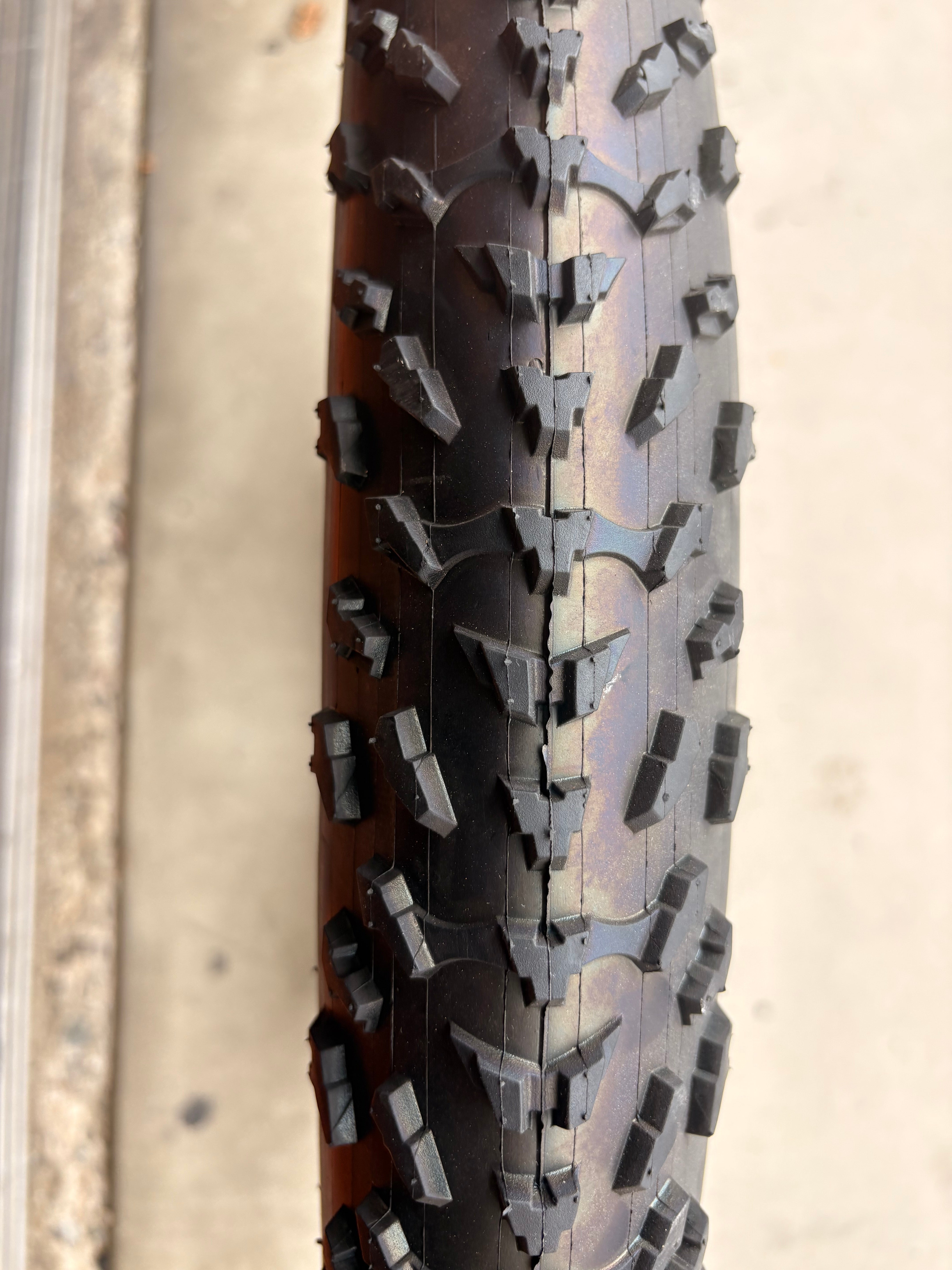 A 26x4 Kenda Krusade fat tire for an eBike, featuring a reflective sidewall, displayed against a plain background.