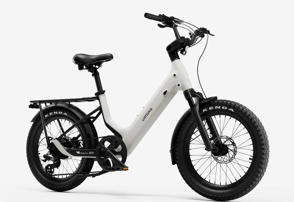 Side view of the Urtopia Carbon Joy eBike in creme color, showcasing its lightweight carbon frame, sleek design, and integrated battery against a plain background.