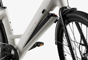 Side view of the Urtopia Carbon Classic Step Thru eBike in creme color, showcasing its lightweight carbon frame, step-through design, and sleek modern styling against a plain background.