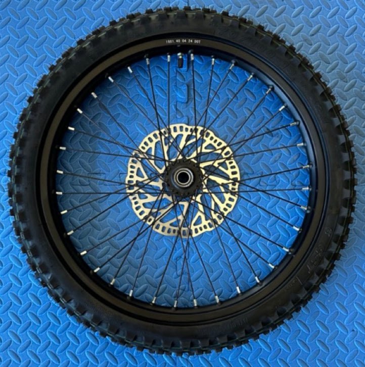 Alt text: Surron eMoto CST Knobby 19-inch front and rear wheel and tire set for electric dirt bikes, shown without rotor or sprocket.