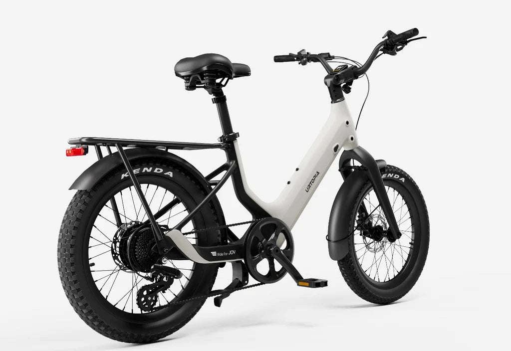 Side view of the Urtopia Carbon Joy eBike in creme color, showcasing its lightweight carbon frame, sleek design, and integrated battery on a white background.