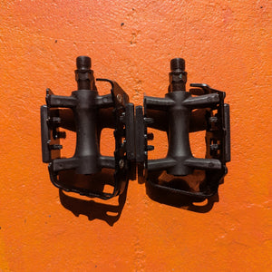 Close-up view of a pair of metal eBike pedals in Style 7, featuring a textured surface and sturdy construction, displayed on a white background.