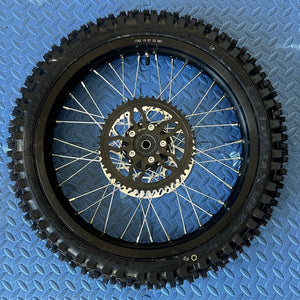 Product image of the eMOTO Surron eMoto Wheel Set featuring CST knobby tires, 17-inch front and 19-inch rear wheels, designed for electric dirt bikes; rotors and sprockets not included.