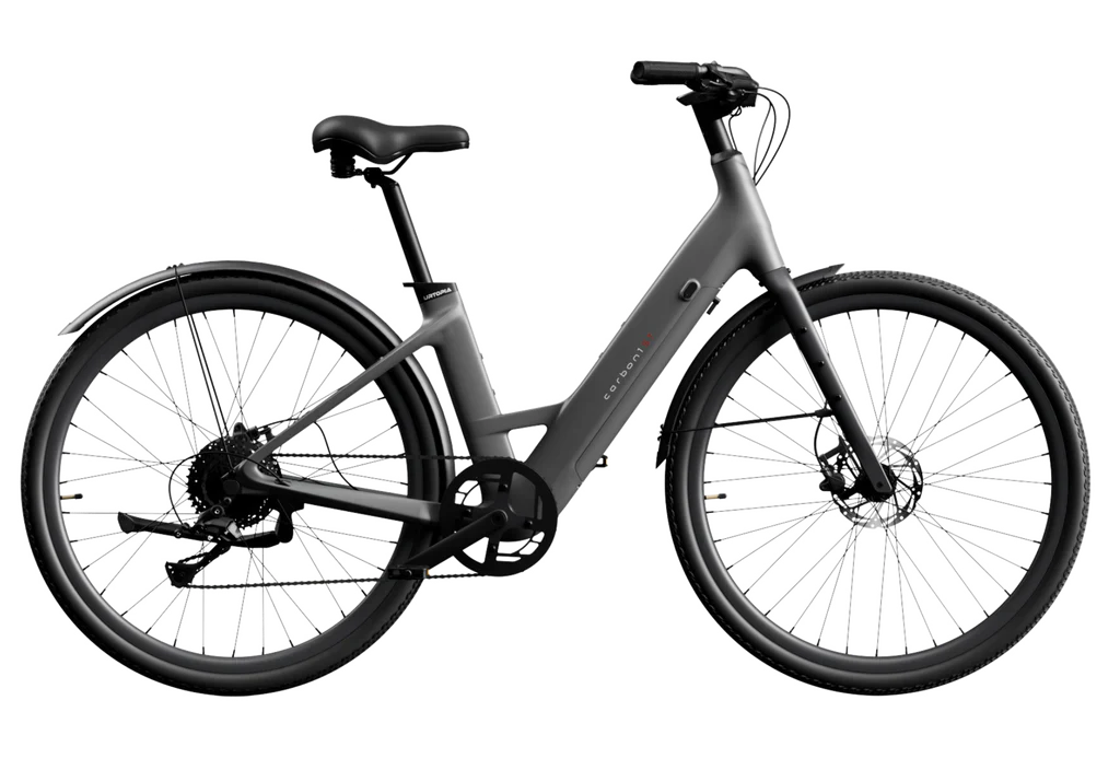 A sleek black Urtopia Carbon 1 Step Thru eBike with a lightweight carbon fiber frame, step-through design, and integrated display, shown from a side angle against a white background.
