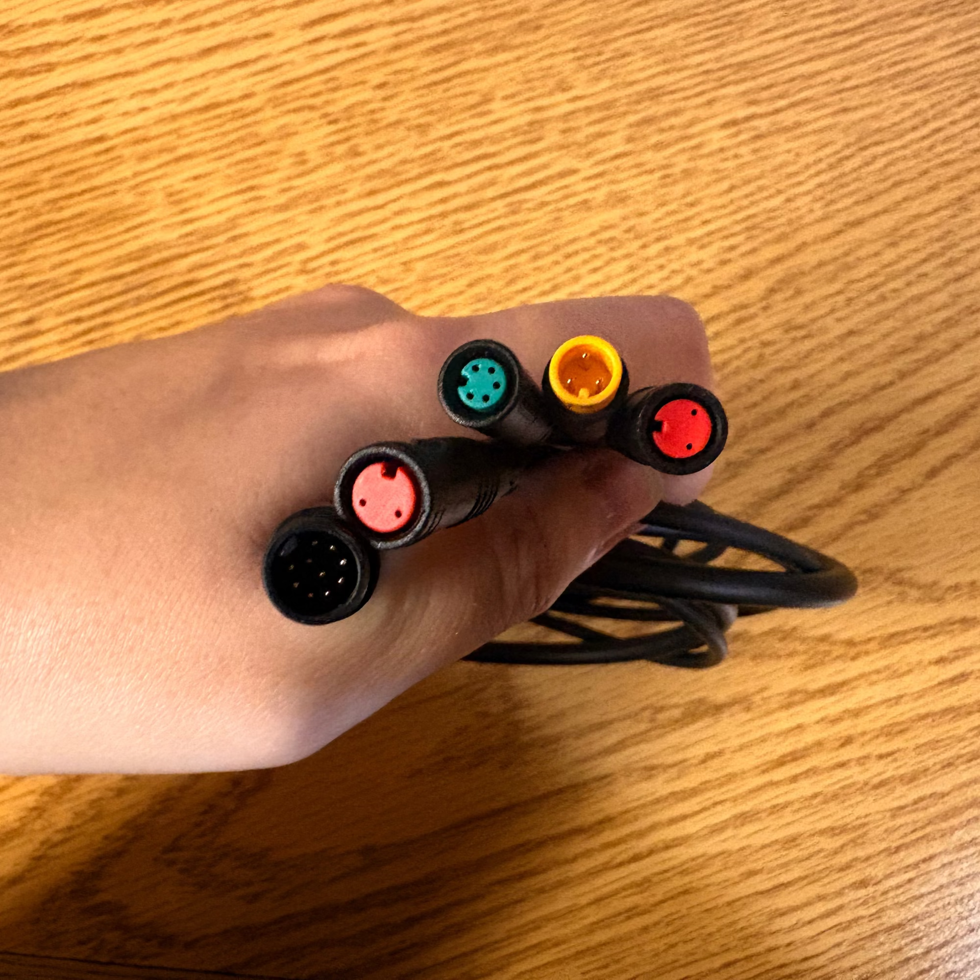 Close-up view of the Mokwheel eBike wiring harness compatible with Basalt 2.0, Obsidian 2.0, and Asphalt 2.0 models, showing multiple connectors and bundled wires.