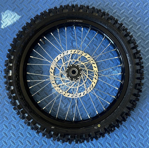 CST knobby 17-inch front wheel and tire set for Surron eMoto electric dirt bikes, shown without rotor or sprocket.