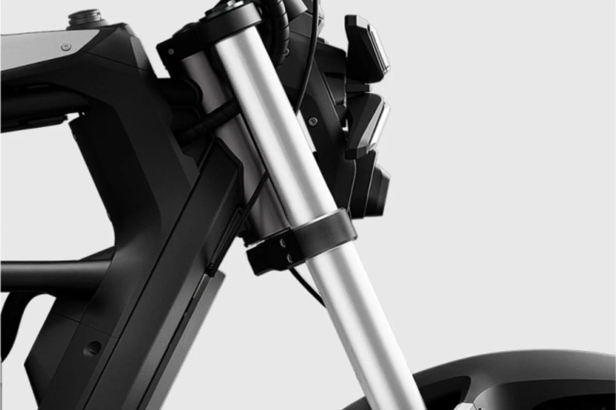 A black eMOTO Segway Xyber electric bike parked outdoors, showcasing its rugged frame, thick tires, and modern design.