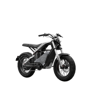 Side view of the eMOTO Segway Xyber electric bike in a studio setting, showcasing its rugged frame, large tires, and modern design features.