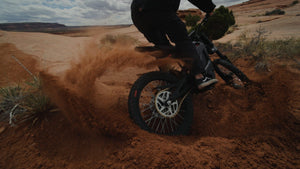 Side view of the eMOTO eRide Pro SS 2.0 electric dirt bike in black, featuring 19x3 off-road tires, a robust frame, and a visible suspension system.