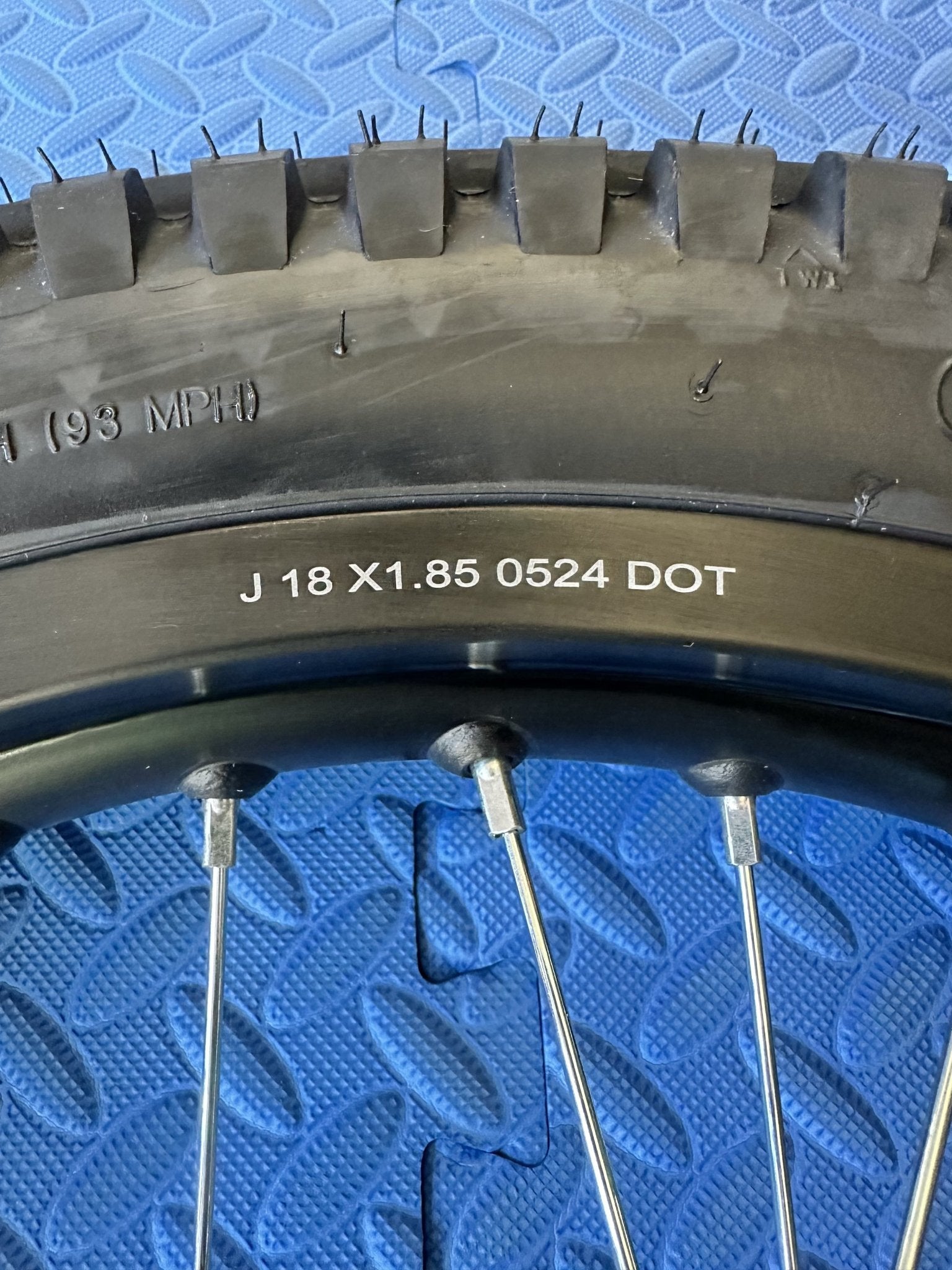 Surron eMoto wheel set with Shinko 241 dual sport tires, 18-inch rear and 21-inch front wheels for moto bikes, shown without rotor or sprocket.