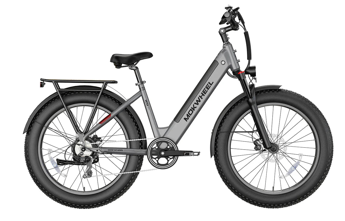 Grey MOKWHEEL Mesa Plus ST 750W step-thru electric bike with 26x4 fat tires, beach cruiser style, shown in side profile.