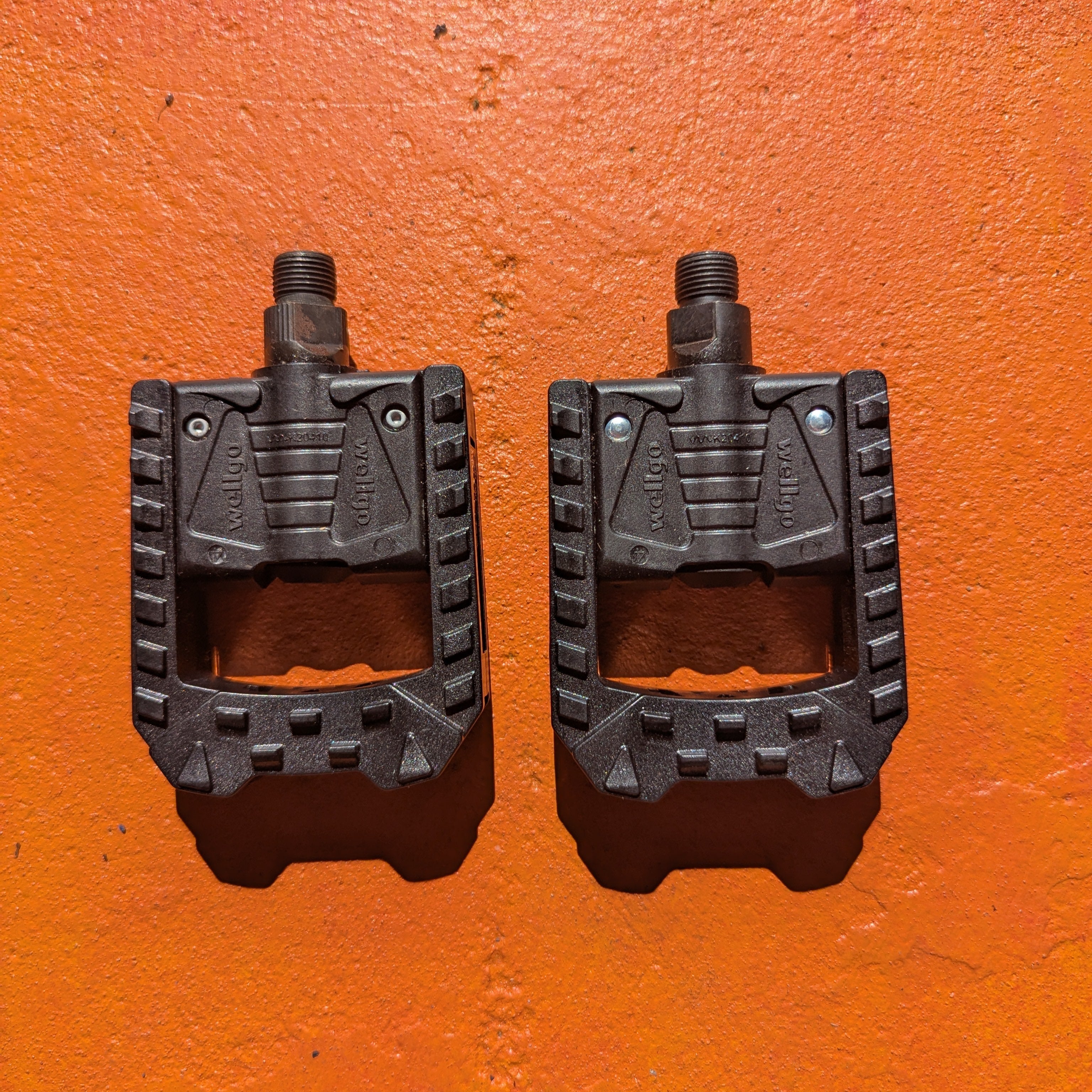 Black nylon folding eBike pedal shown in a folded position on a white background.