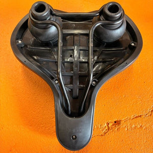 Black city-style eBike seat with ergonomic design, slightly curved shape, and visible stitching, photographed against a white background.