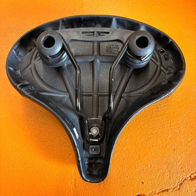 A black eBike seat in a beach cruiser style with a wide, cushioned design and smooth, contoured surface, shown against a plain background.