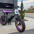 Black and purple eMOTO eBike Macfox X1S CUSTOM, ready to ride, side view against a plain background.