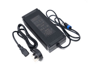 Front view of the Stomp Ebox stock charger showing its compact black rectangular design with attached power cable and indicator lights.