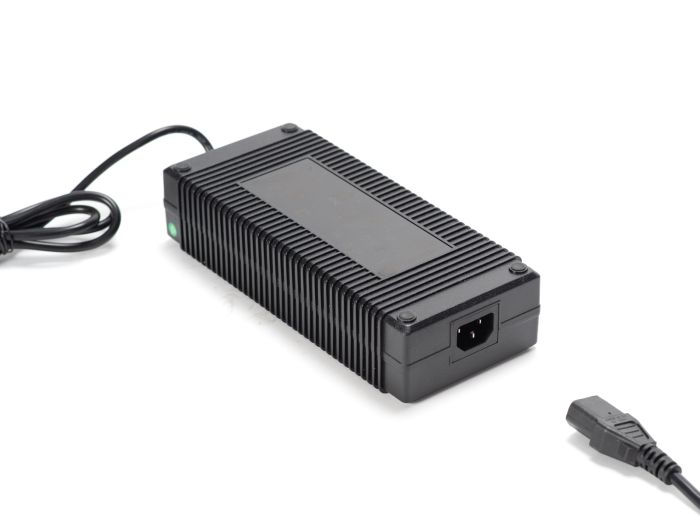 Stomp Ebox stock charger with attached power cable, shown on a white background.