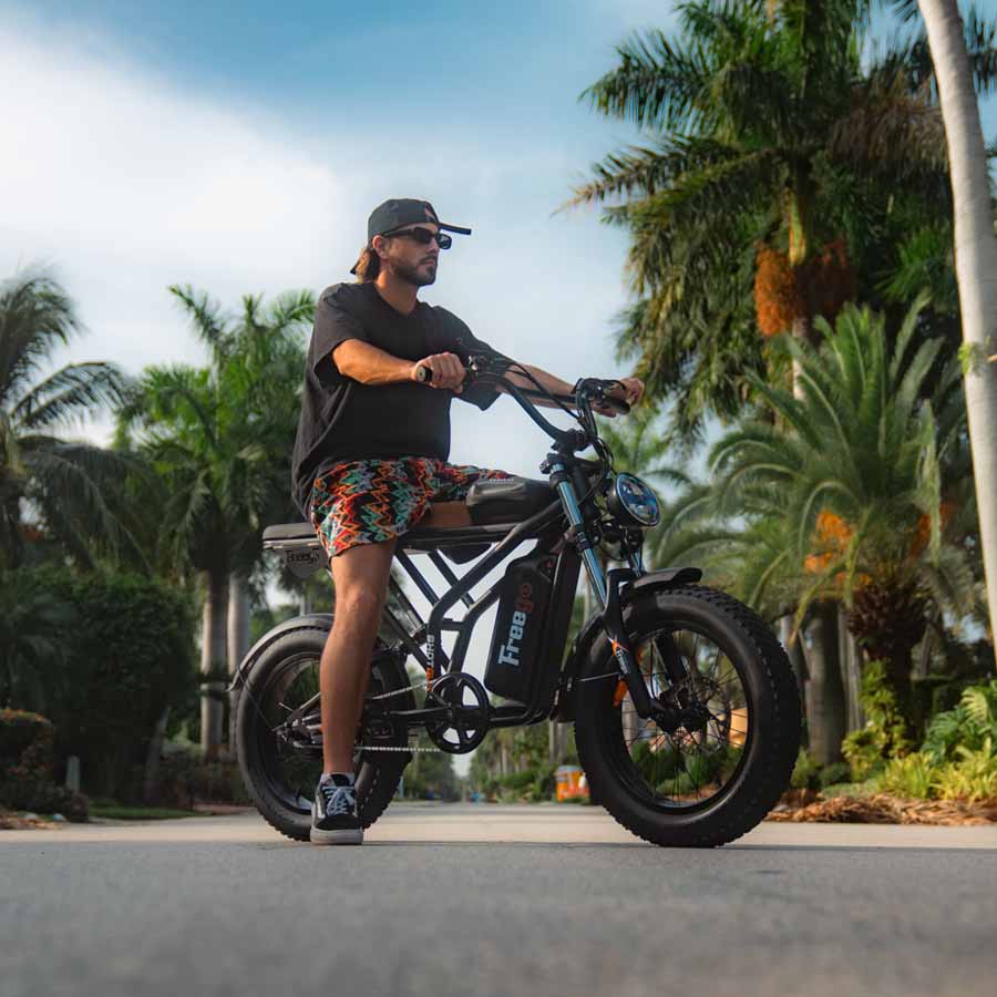 Side view of the eMOTO FREEGO Electric e-Moto Style eBike Shotgun Prime F2 Pro-Moto 1000W Electric Cargo eBike, showcasing its sturdy frame, large tires, and rear cargo rack.