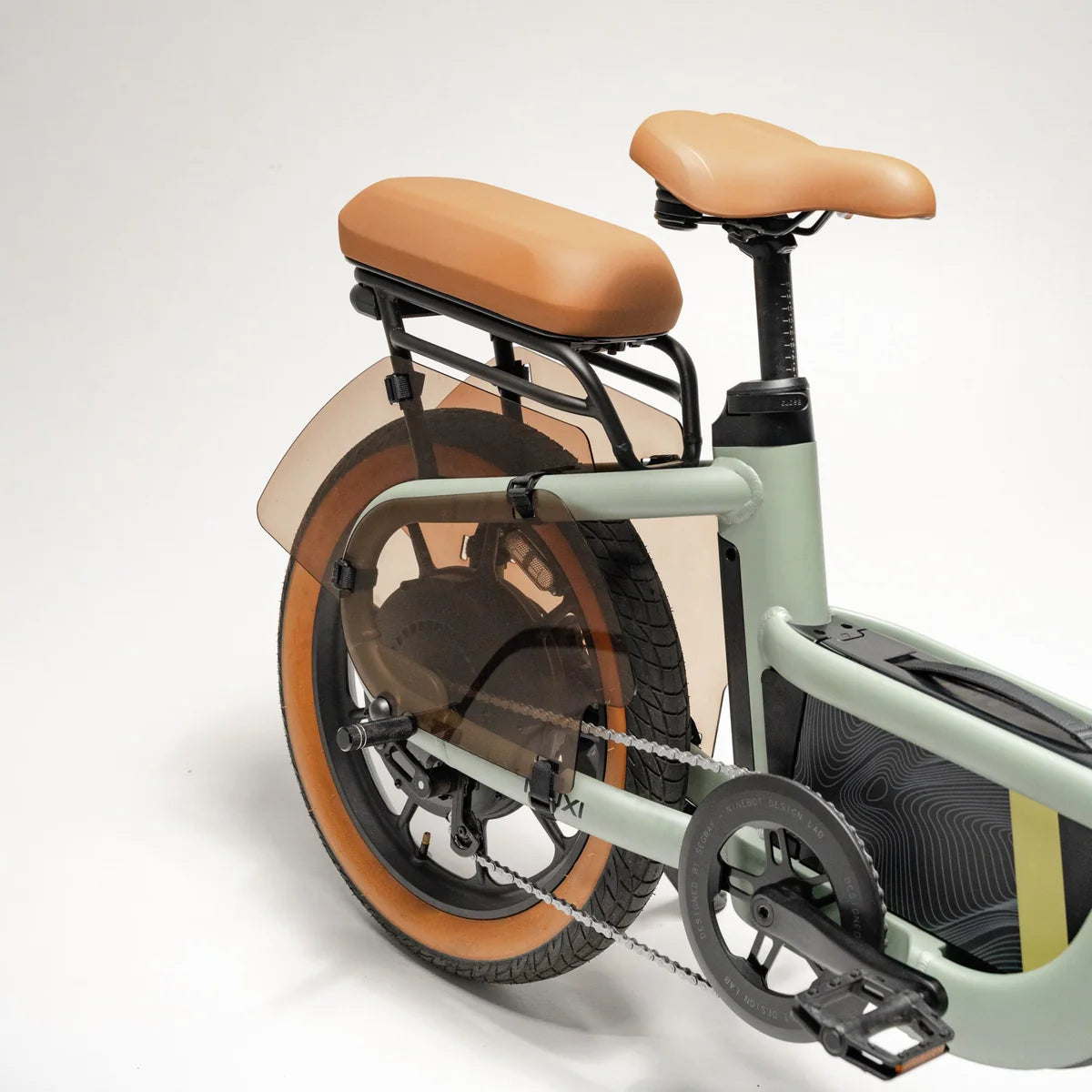 Electric bike Segway Muxi, side view, black frame, parked on pavement with greenery in background