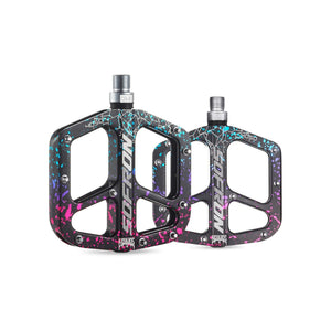 Alloy eBike pedals in a rainbow camouflage pattern, side view on a white background