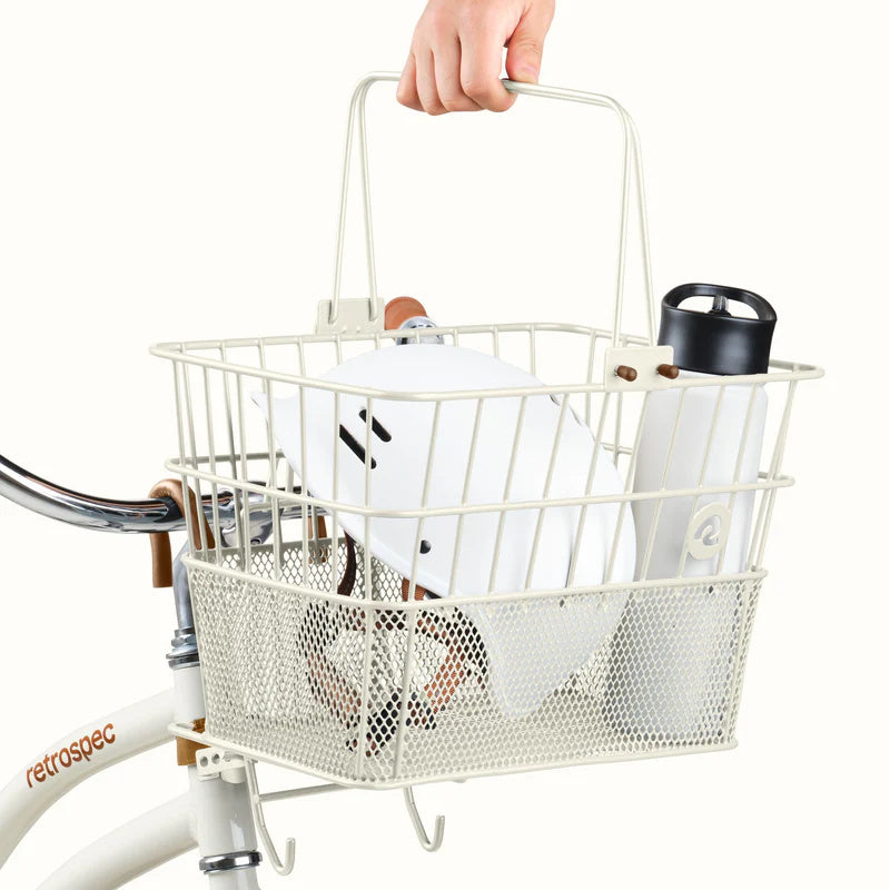 Retrospec Apollo steel bike basket in eggshell color attached to an eBike, product image.