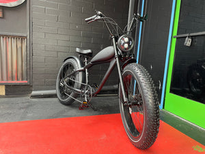 Black Cheetah electric fat-tire custom eBike, side view, with thick tires and sleek frame
