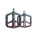 Alloy eBike pedals in a rainbow camouflage pattern, shown from a side angle on a white background.