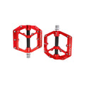 Red and black alloy eBike pedals with a sleek design, shown on a black background.