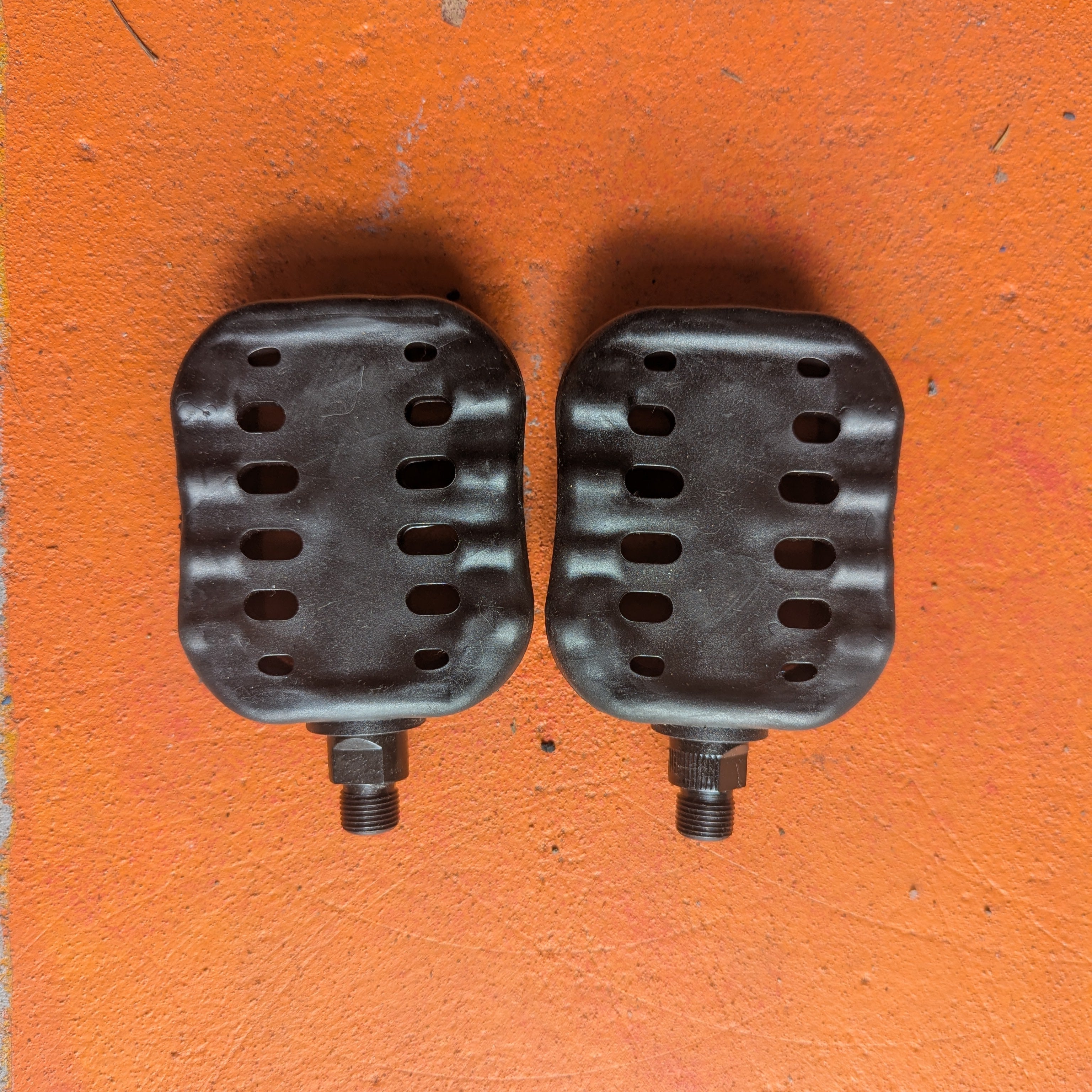 Metal eBike pedals in beach cruiser style, shown close-up against a plain background.