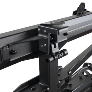 A black Cravot CyberRack R2 eBike hitch rack with an integrated ramp accessory, shown mounted on the back of a vehicle, holding two electric bikes securely.