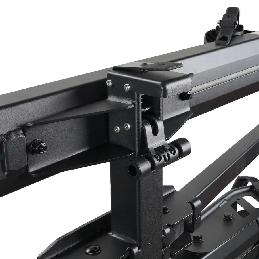 A black Cravot CyberRack R2 eBike hitch rack with an integrated ramp accessory, shown mounted on the back of a vehicle, holding two electric bikes securely.