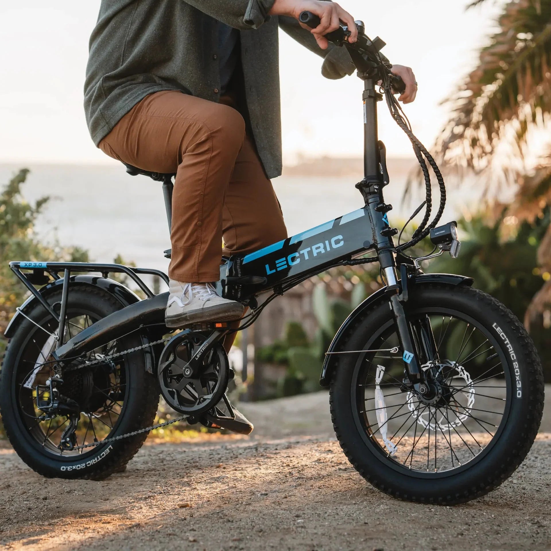 A black Lectric XP 3.0 folding fat tire eBike with a step-over frame, 500W motor, and commuter-friendly design, shown in a side profile with thick tires and compact folding structure.