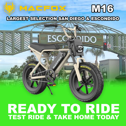 Macfox M16 eBike in Desert Beige color, side view, parked on rugged terrain with a desert background.