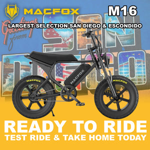 Black Macfox M16 eBike parked outdoors in San Diego, side view, with cityscape background