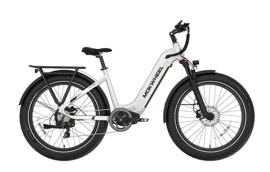 White MOKWHEEL Basalt ST 750W step-thru electric bike with 26x4 fat tires, beach cruiser style, shown from the side.