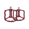 Red camouflage alloy eBike pedals with a textured surface, shown in a product image.