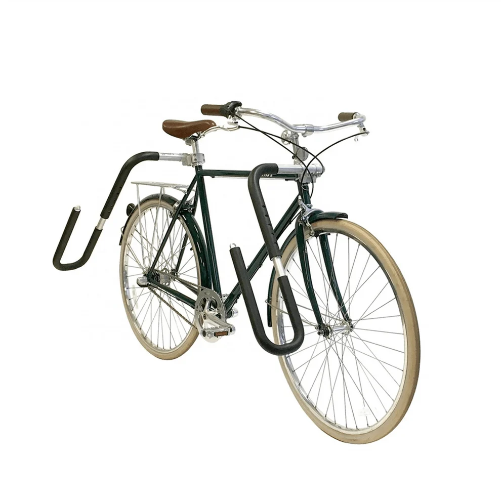 An eBike equipped with a surfboard rack mounted on the side, securely holding a surfboard, shown outdoors.