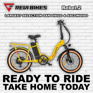 Yellow eBike Revi Rebel.2 R2R electric bicycle, side view, showcasing frame design and battery placement