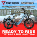 Electric bike in water blue color, side view, featuring a step-through frame and rear cargo rack, photographed against a plain background.