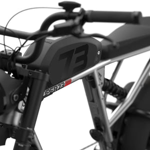 Super73 R Brooklyn SE electric bike in metallic aluminum finish, side view, displayed against a plain background