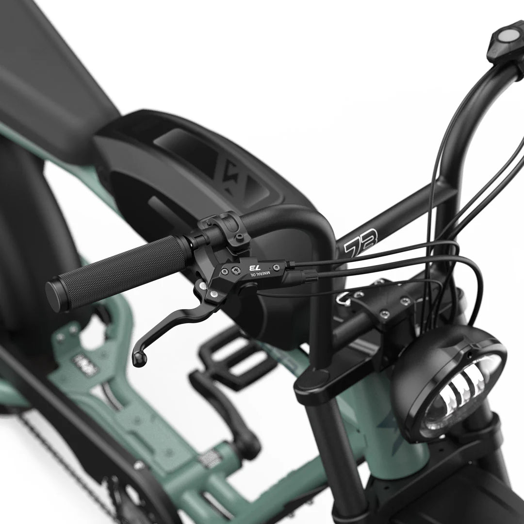Side view of the Super73 S2 Laguna electric bike in a coastal setting, highlighting its sleek frame, wide tires, and modern design features.