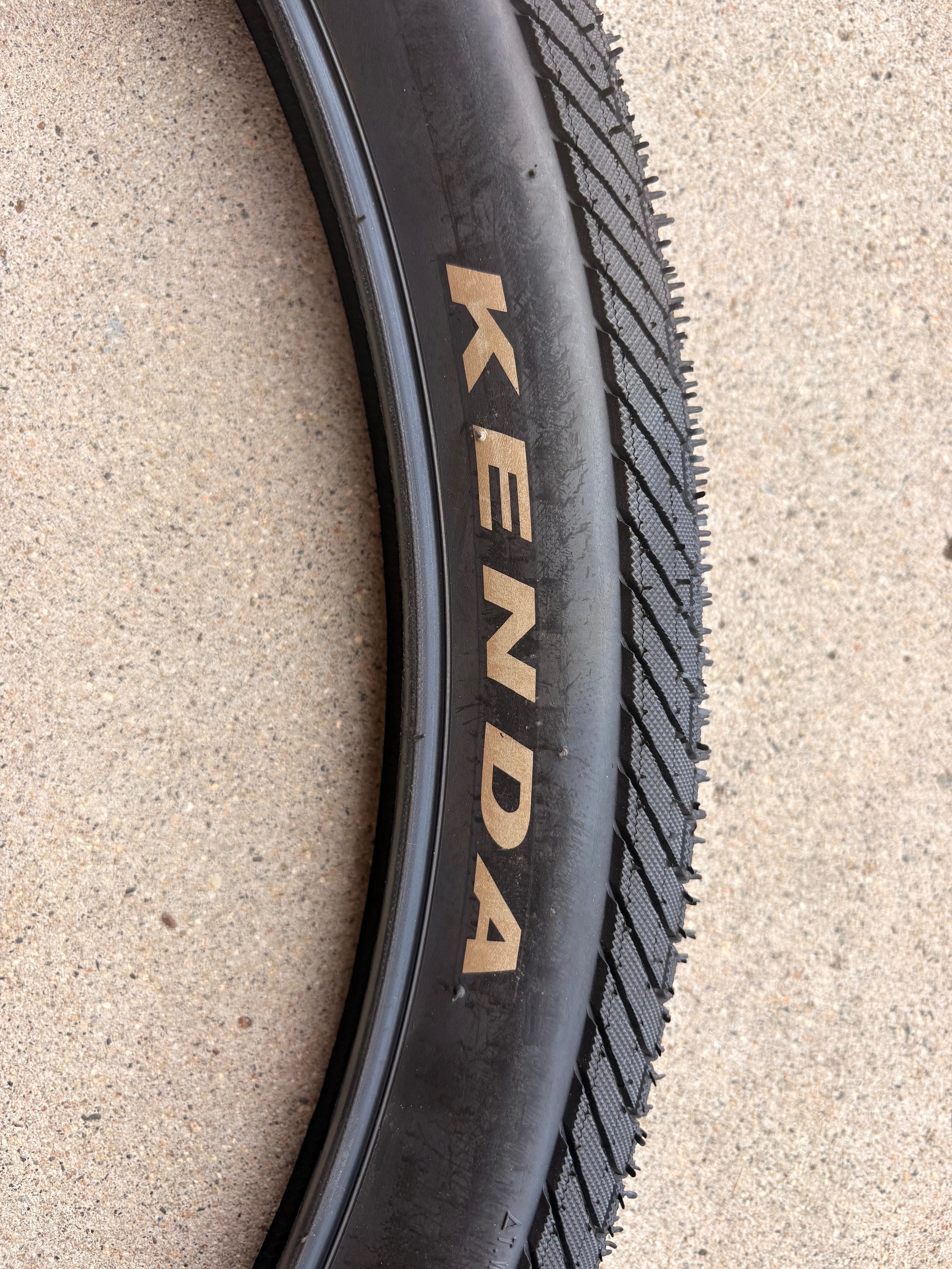 Product image of a Kenda Kwick Seven.5 eBike tire, size 27.5x2.20, showing tread pattern and sidewall branding.