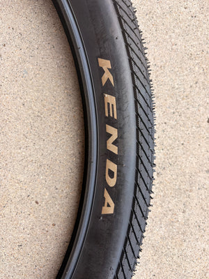 Product image of a Kenda Kwick Seven.5 eBike tire, size 27.5x2.20, showing tread pattern and sidewall branding.