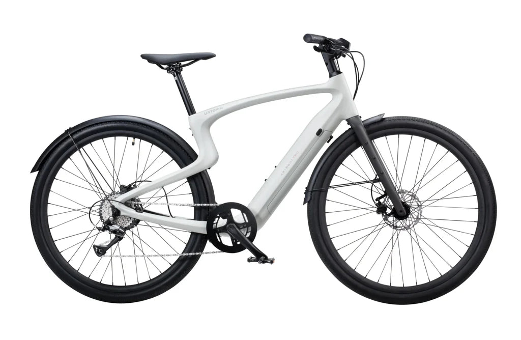 A creme-colored Urtopia Carbon 1 Pro eBike displayed from a side angle, showcasing its lightweight carbon frame, integrated battery, and sleek modern design.