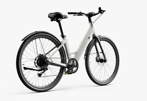 Side view of the Urtopia Carbon 1 Step Thru eBike in creme color, showcasing its lightweight carbon frame, step-through design, and integrated battery.