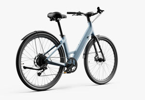 Side view of the Urtopia Carbon 1 Step Thru eBike in Glacier Blue, showcasing its lightweight carbon frame, step-through design, and sleek modern styling against a plain background.